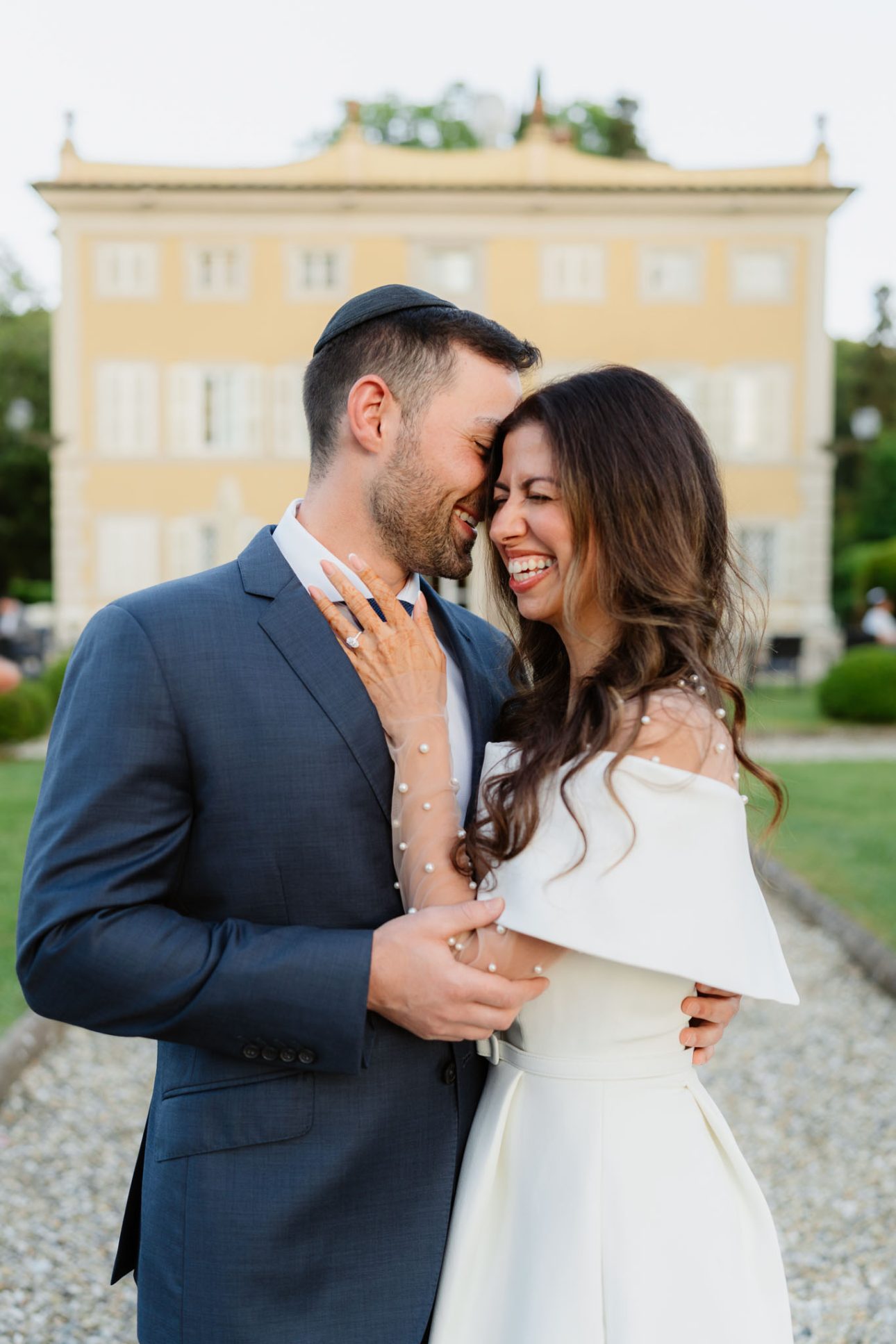 Bride and groom laughing in front of Villa Lenka Coselli Collection Tuscany